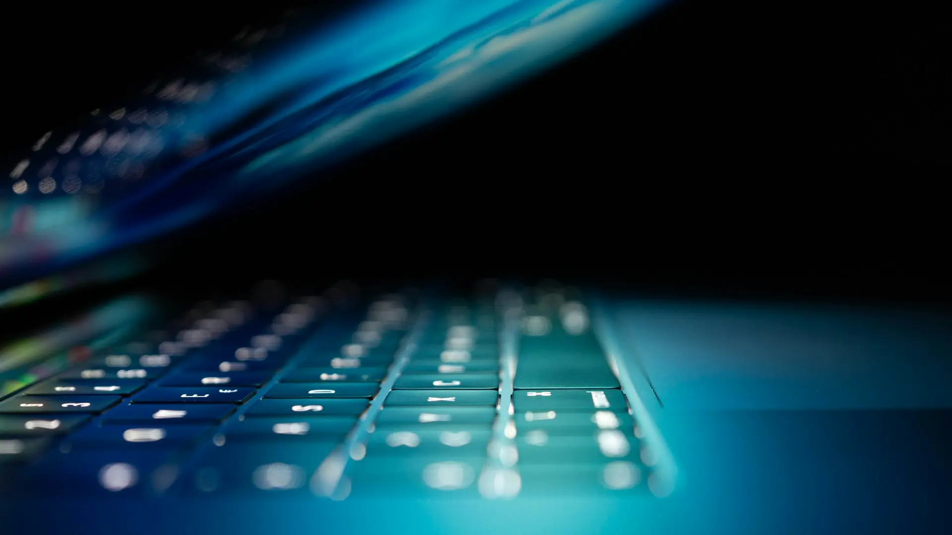 closeup photo of turned-on blue and white laptop computer